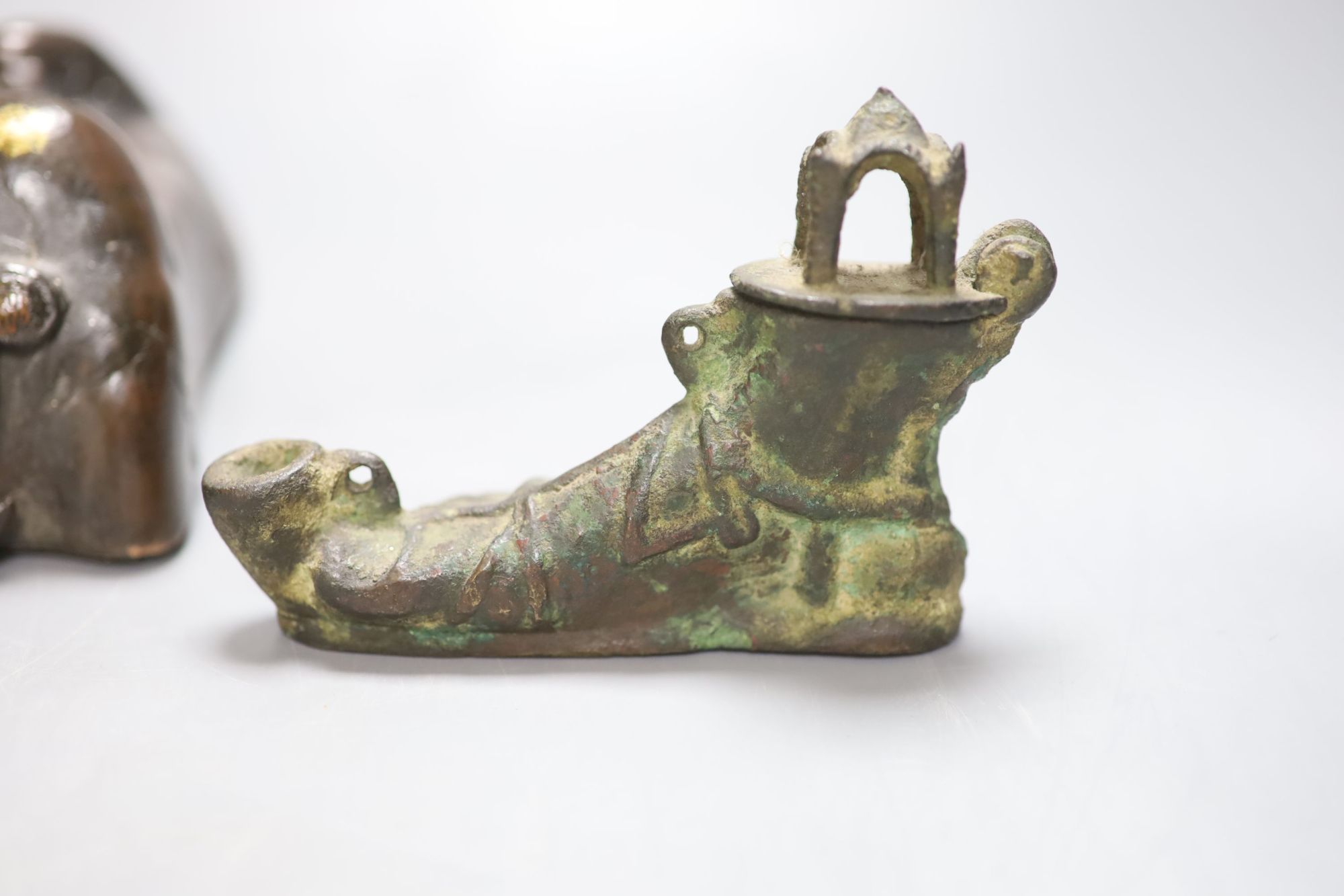 A Chinese bronze model of an immortal and dragon and a tripod censer, 18th century and later and a Greek bronze model of a shoe